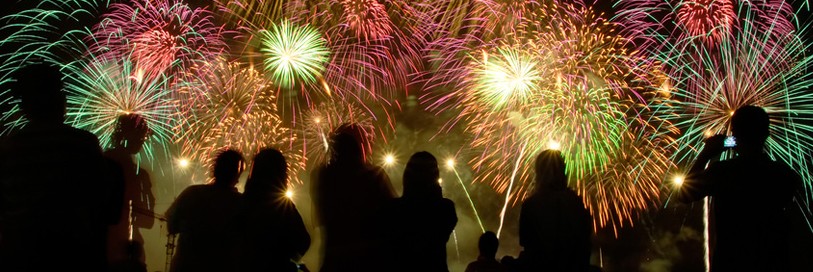 silhouette of crowds watching fireworks