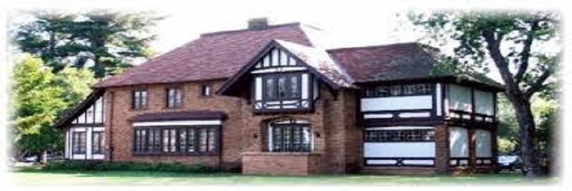 a large house with green trees around it